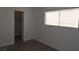 Well-lit bedroom showing window, fresh paint, and new laminate flooring at 3101 E Carey Ave, North Las Vegas, NV 89030