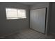 Bedroom features tile flooring, neutral walls, a double window, and a closet with sliding doors at 3101 E Carey Ave, North Las Vegas, NV 89030