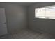 Bedroom features tile flooring, neutral walls, and a double window at 3101 E Carey Ave, North Las Vegas, NV 89030