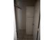 A closet features storage shelves and a door with tile flooring at 3101 E Carey Ave, North Las Vegas, NV 89030