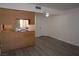 Open-concept kitchen with wood cabinets, modern flooring, and an adjacent living area at 3101 E Carey Ave, North Las Vegas, NV 89030