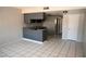 This living room features tile flooring and an open kitchen at 3101 E Carey Ave, North Las Vegas, NV 89030
