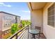 Balcony seating area overlooking trees and blue sky at 3159 Via Como, Henderson, NV 89044