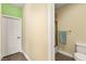 Bright bathroom featuring tile floors, a toilet, and a view of a shower/tub with glass door at 3159 Via Como, Henderson, NV 89044