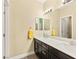 Bathroom featuring a double sink vanity with a large mirror and modern lighting fixtures at 3159 Via Como, Henderson, NV 89044