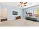 Bright bedroom featuring a treadmill, television, and natural light from two large windows at 3159 Via Como, Henderson, NV 89044