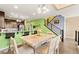 Bright dining room featuring modern light fixture and open access to kitchen at 3159 Via Como, Henderson, NV 89044