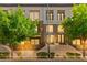Inviting multi-level home featuring a blend of neutral tones, brick accents, and lush landscaping at 3159 Via Como, Henderson, NV 89044