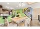 Bright kitchen and dining area with stylish barstool seating, stainless appliances, and an open floorplan at 3159 Via Como, Henderson, NV 89044