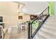 Stylish living room with stairs, dining area, and modern kitchen in an open concept design at 3159 Via Como, Henderson, NV 89044