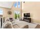 Cozy living area with high ceilings, a fireplace, and french doors leading to a balcony at 3159 Via Como, Henderson, NV 89044