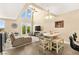 Living area featuring high ceilings, a dining area, and french doors leading to a balcony at 3159 Via Como, Henderson, NV 89044