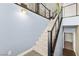 Stylish staircase featuring carpeted steps, sleek metal railings, and modern design accents at 3159 Via Como, Henderson, NV 89044