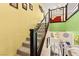 Carpeted staircase with dark wood and horizontal bar railing leads to the upper level at 3159 Via Como, Henderson, NV 89044