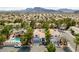Aerial view of homes with pools, mature landscaping, and mountain views at 3481 Creek River Dr, Las Vegas, NV 89129