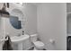 Bright bathroom featuring a pedestal sink and a round mirror at 3481 Creek River Dr, Las Vegas, NV 89129