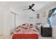 Bright bedroom featuring a ceiling fan and closet for ample storage at 3481 Creek River Dr, Las Vegas, NV 89129