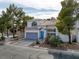 Two-story home with a tile roof and attached garage, near trees and a community pool at 3481 Creek River Dr, Las Vegas, NV 89129