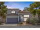 Two-story home featuring a xeriscaped front yard, tile roof, and attached two-car garage at 3481 Creek River Dr, Las Vegas, NV 89129