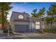 Two-story home with xeriscaping and a tile roof stands adjacent to a neighboring residence at 3481 Creek River Dr, Las Vegas, NV 89129
