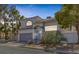Charming two-story home with a tile roof and a well-manicured, xeriscaped front yard at 3481 Creek River Dr, Las Vegas, NV 89129
