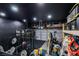 Customized garage gym including weights, work out machines and overhead storage at 3481 Creek River Dr, Las Vegas, NV 89129