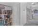 Hallway featuring built-in bookcases, perfect for storage and display at 3481 Creek River Dr, Las Vegas, NV 89129
