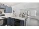 Galley kitchen open to dining area featuring stainless appliances and bright countertops at 3481 Creek River Dr, Las Vegas, NV 89129