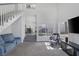 Bright living room with tall ceilings, large windows, and a staircase to the second level at 3481 Creek River Dr, Las Vegas, NV 89129