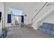 Bright living room with tall ceilings, large windows, and a staircase to the second level at 3481 Creek River Dr, Las Vegas, NV 89129