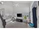 Living room with a ceiling fan, big windows, and a tall ceiling with a view to a second floor at 3481 Creek River Dr, Las Vegas, NV 89129