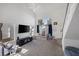 Bright living room with high ceilings, large window and adjacent staircase to upper level at 3481 Creek River Dr, Las Vegas, NV 89129