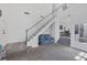 Bright living room featuring tall ceilings, stairs to the second level, and a view into other rooms at 3481 Creek River Dr, Las Vegas, NV 89129