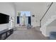 Bright living room with tall ceilings, large windows, and a staircase to the second level at 3481 Creek River Dr, Las Vegas, NV 89129