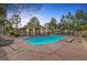 Sparkling community pool surrounded by lounge chairs and a covered patio area for relaxation at 3481 Creek River Dr, Las Vegas, NV 89129