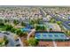 Aerial view of a park with playground, tennis and pickleball courts, and paved walking paths at 3481 Creek River Dr, Las Vegas, NV 89129
