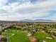 Picturesque aerial view of a golf course with lush green fairways and strategically placed sand traps at 3481 Creek River Dr, Las Vegas, NV 89129