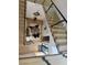 Staircase landing features glass railings and opens to the entry way with hardwood floors and modern decor at 358 Solitude Peak Ln, Henderson, NV 89012
