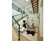 Staircase with glass railings, light wood stairs, and modern decor at 358 Solitude Peak Ln, Henderson, NV 89012