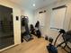 Well-equipped home gym featuring multiple workout machines and natural light at 358 Solitude Peak Ln, Henderson, NV 89012