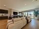 Bright living room features a fireplace, hardwood floors, and large windows overlooking the city at 358 Solitude Peak Ln, Henderson, NV 89012