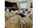 Spacious living area featuring a curved sofa, modern furnishings, and a view of the outdoors at 358 Solitude Peak Ln, Henderson, NV 89012