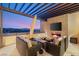 Inviting outdoor living space featuring a fireplace with comfortable seating and mountain views at 358 Solitude Peak Ln, Henderson, NV 89012