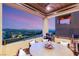 Outdoor patio with a dining table, grill, and panoramic city views at 358 Solitude Peak Ln, Henderson, NV 89012
