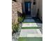 Modern walkway with stone pavers, green turf accents, and desert landscaping at 358 Solitude Peak Ln, Henderson, NV 89012