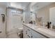 Bright bathroom featuring a double sink vanity, shower over tub, and natural light at 4160 Elegant Chateau St, Las Vegas, NV 89135