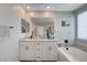 Bright bathroom featuring a double sink vanity, soaking tub, and recessed lighting at 4160 Elegant Chateau St, Las Vegas, NV 89135