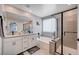 Bright bathroom showcasing a double sink vanity, soaking tub, and glass enclosed shower at 4160 Elegant Chateau St, Las Vegas, NV 89135