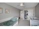 Bedroom with plush carpeting, a ceiling fan, closet, window, crib and toddler bed at 4160 Elegant Chateau St, Las Vegas, NV 89135
