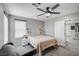Comfortable bedroom with neutral walls, ceiling fan, carpet, and a large window with natural light at 4160 Elegant Chateau St, Las Vegas, NV 89135